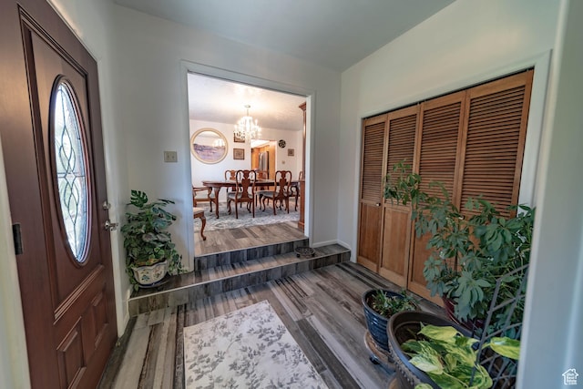 2317 N Hillside Dr, Wellington, UT 84542 - entryway with an inviting chandelier, wood finished floors, and baseboards