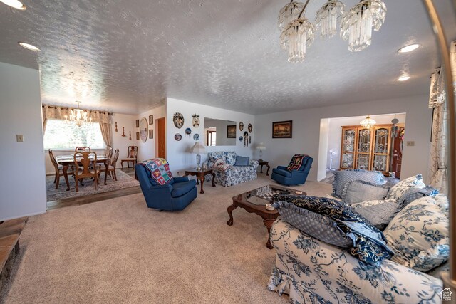 2317 N Hillside Dr, Wellington, UT 84542 - living room featuring recessed lighting, a textured ceiling, carpet flooring, and an inviting chandelier