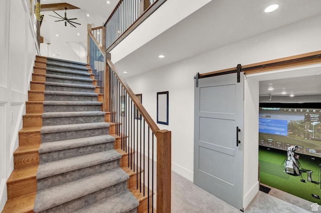 8122 S Willow Creek Cv, Cottonwood Heights, UT 84093 - stairs featuring ceiling fan, a barn door, and a high ceiling