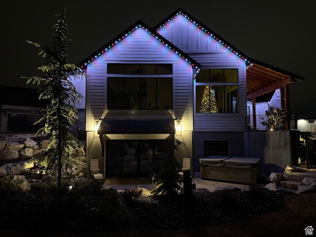 8122 S Willow Creek Cv, Cottonwood Heights, UT 84093 - back house at twilight with a hot tub