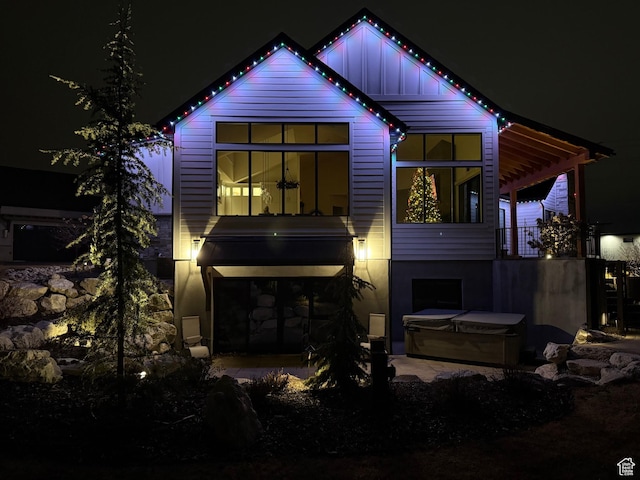 8122 S Willow Creek Cv, Cottonwood Heights, UT 84093 - back house at twilight featuring a hot tub