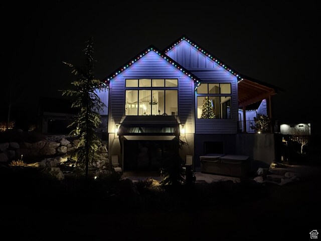 8122 S Willow Creek Cv, Cottonwood Heights, UT 84093 - back house at night with a hot tub