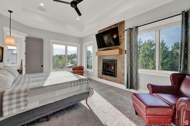 8122 S Willow Creek Cv, Cottonwood Heights, UT 84093 - carpeted bedroom with a tray ceiling, a large fireplace, and ceiling fan
