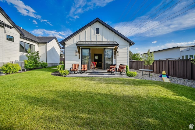 8122 S Willow Creek Cv, Cottonwood Heights, UT 84093 - rear view of property with a patio and a lawn
