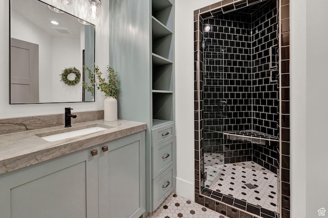 8122 S Willow Creek Cv, Cottonwood Heights, UT 84093 - bathroom featuring vanity, tile patterned floors, and a tile shower