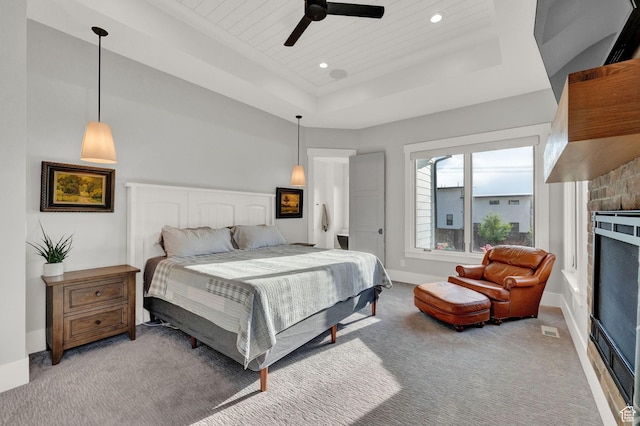 8122 S Willow Creek Cv, Cottonwood Heights, UT 84093 - bedroom with light carpet, wooden ceiling, a tray ceiling, ceiling fan, and a fireplace