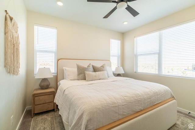 bedroom featuring ceiling fan and multiple windows