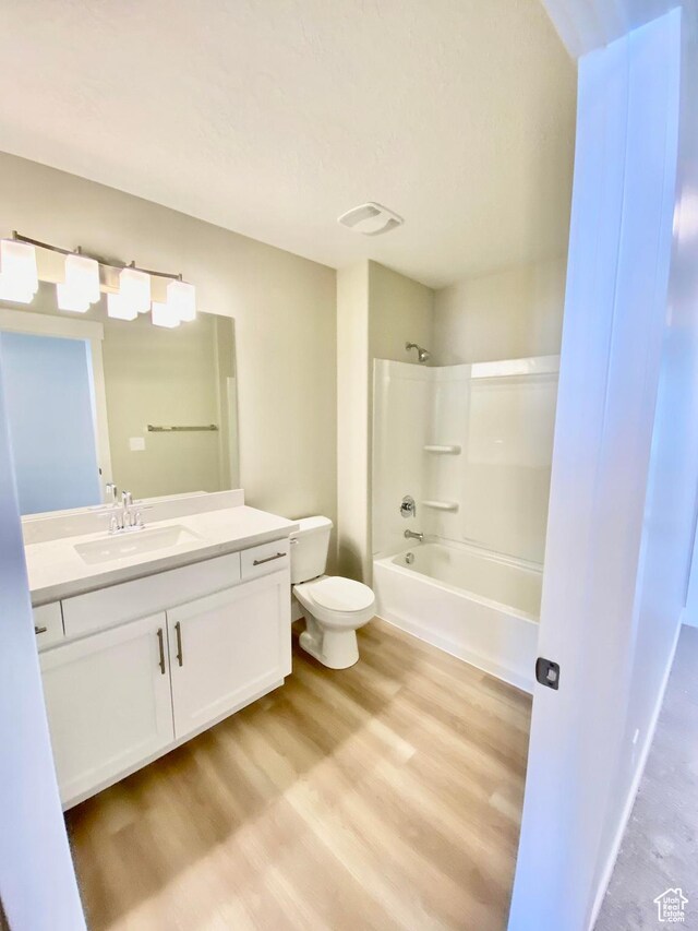 1688 N Centerpoint Ln, Salem, UT 84653 - bathroom with toilet, vanity, wood finished floors, and shower / tub combination
