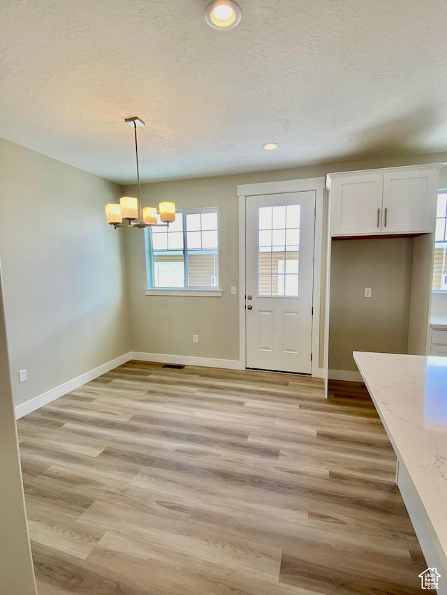 1688 N Centerpoint Ln, Salem, UT 84653 - unfurnished dining area featuring a chandelier, a textured ceiling, light wood finished floors, baseboards, and recessed lighting