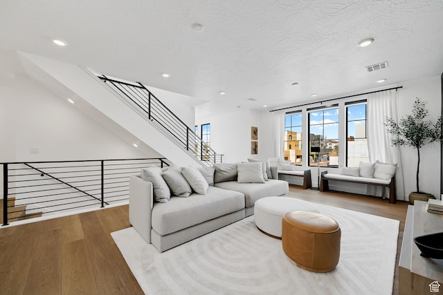 5466 S Persian Ln, St George, UT 84790 - living room featuring a textured ceiling and light hardwood / wood-style flooring
