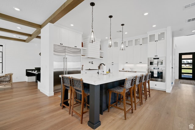 5466 S Persian Ln, St George, UT 84790 - kitchen featuring beamed ceiling, stainless steel appliances, white cabinetry, and a large island