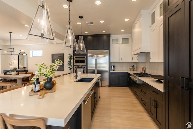 5355 S Cyan Ln, St George, UT 84790 - kitchen with white cabinetry, sink, stainless steel appliances, pendant lighting, and a spacious island