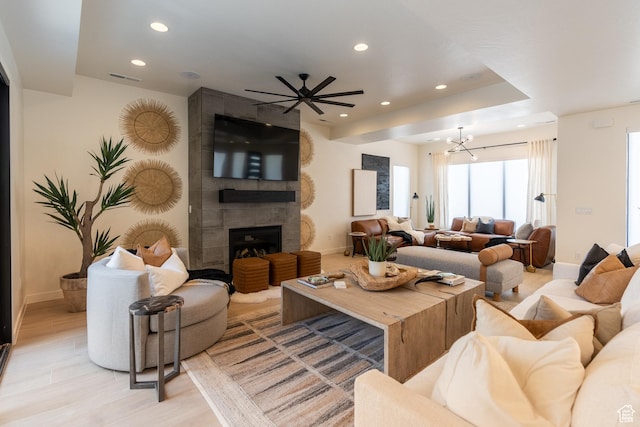 5355 S Cyan Ln, St George, UT 84790 - living room featuring a fireplace, light hardwood / wood-style floors, and ceiling fan with notable chandelier