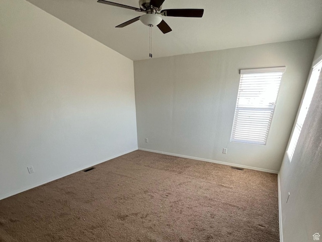 spare room with visible vents, baseboards, carpet flooring, and a ceiling fan