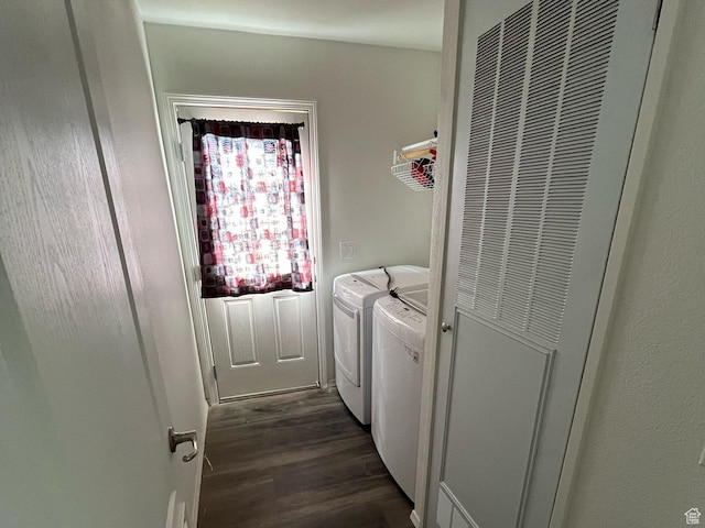 clothes washing area featuring washer and dryer, laundry area, and dark wood-type flooring