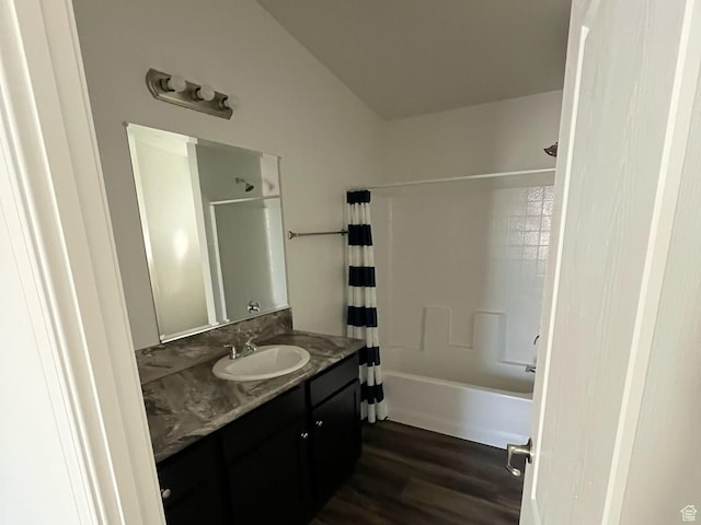 bathroom with shower / tub combo, wood finished floors, and vanity