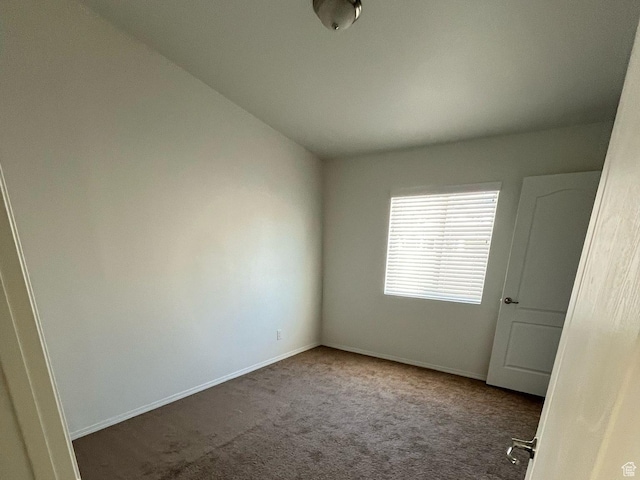 empty room featuring carpet and baseboards