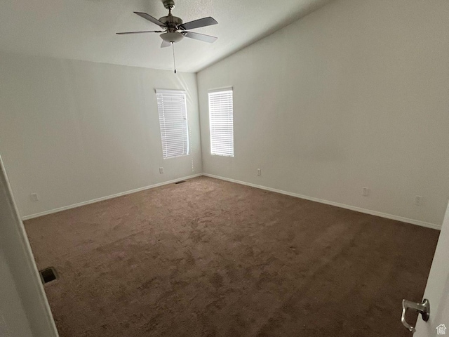 carpeted spare room with baseboards and ceiling fan