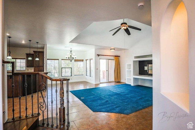 living room with high vaulted ceiling, ceiling fan with notable chandelier, built in features, and light tile patterned floors