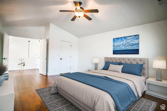 bedroom with vaulted ceiling, dark hardwood / wood-style floors, and ceiling fan