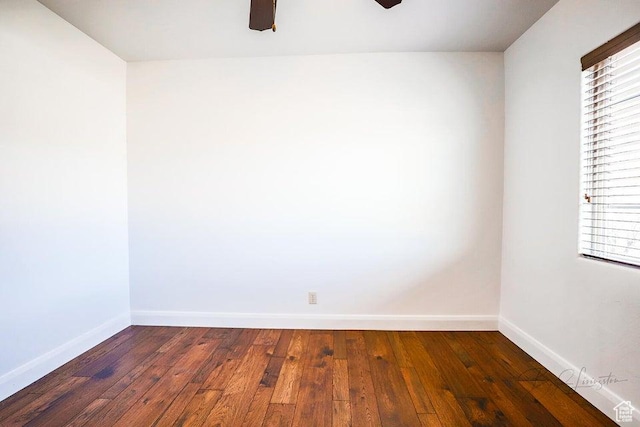 spare room with plenty of natural light, dark wood-type flooring, and ceiling fan