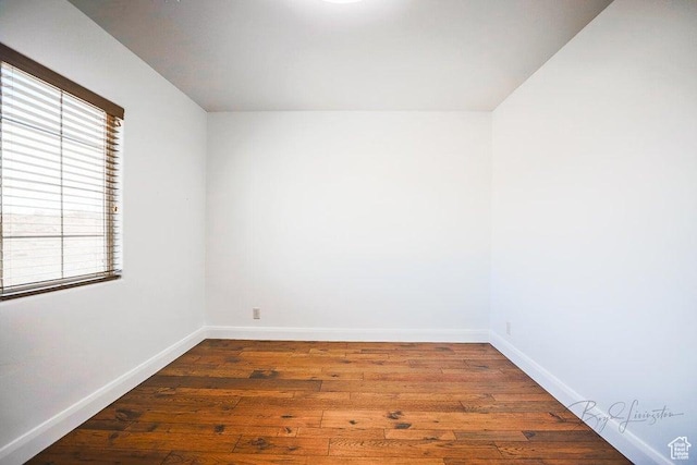 empty room featuring dark hardwood / wood-style flooring