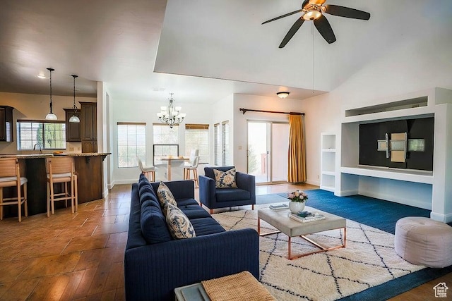 living room featuring dark hardwood / wood-style flooring, sink, and ceiling fan with notable chandelier