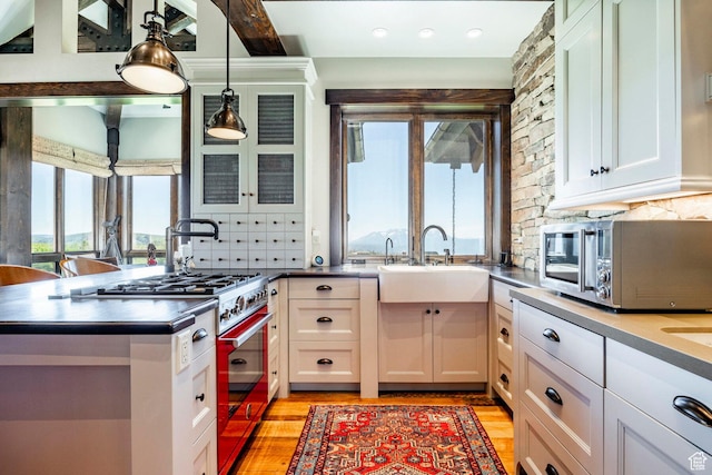10454 E Forest Creek Rd, Kamas, UT 84036 - kitchen featuring tasteful backsplash, a sink, white cabinetry, light wood finished floors, and stainless steel appliances
