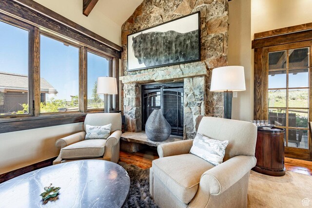 10454 E Forest Creek Rd, Kamas, UT 84036 - sitting room with wood finished floors, vaulted ceiling with beams, and a stone fireplace