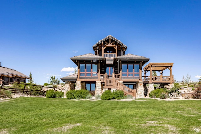 10454 E Forest Creek Rd, Kamas, UT 84036 - back of property with stairs, a balcony, stone siding, and a lawn