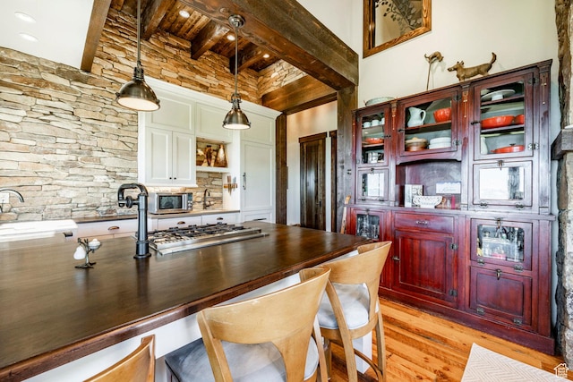 10454 E Forest Creek Rd, Kamas, UT 84036 - kitchen featuring open shelves, appliances with stainless steel finishes, dark countertops, reddish brown cabinets, and light wood finished floors