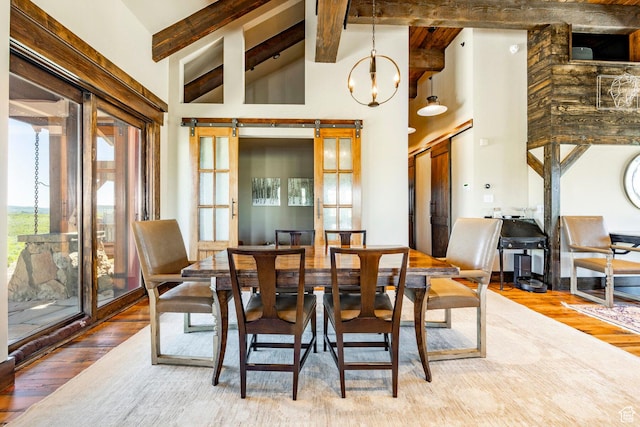10454 E Forest Creek Rd, Kamas, UT 84036 - dining area with wood finished floors, high vaulted ceiling, an inviting chandelier, and beam ceiling