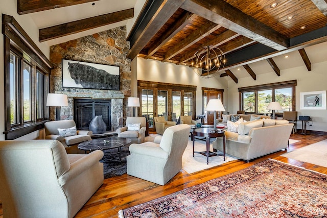 10454 E Forest Creek Rd, Kamas, UT 84036 - living room featuring a stone fireplace, a wealth of natural light, an inviting chandelier, and wood finished floors
