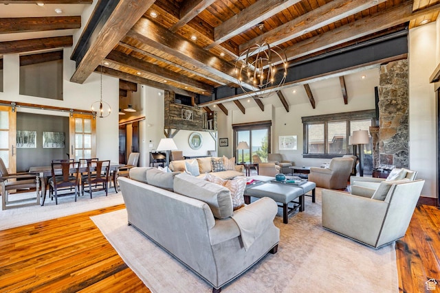10454 E Forest Creek Rd, Kamas, UT 84036 - living area with wood finished floors, an inviting chandelier, beam ceiling, and high vaulted ceiling