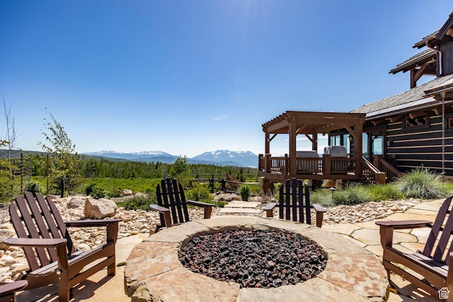 10454 E Forest Creek Rd, Kamas, UT 84036 - view of patio featuring a deck with mountain view, a pergola, and an outdoor fire pit