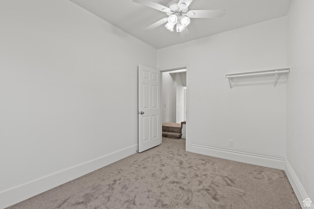 unfurnished bedroom with carpet flooring, baseboards, and ceiling fan