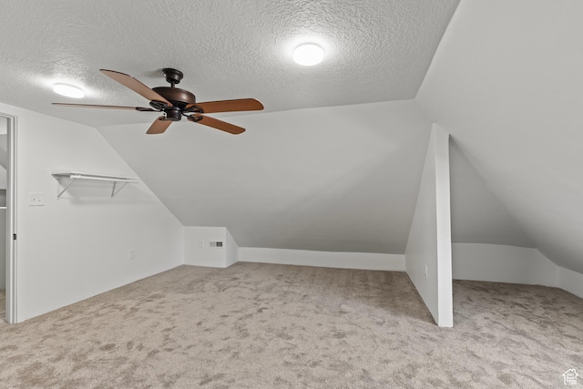 bonus room with ceiling fan, lofted ceiling, and carpet flooring