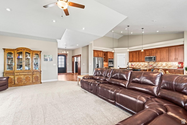 84 W 2100 N, Kamas, UT 84036 - living room featuring baseboards, light colored carpet, ceiling fan with notable chandelier, high vaulted ceiling, and recessed lighting