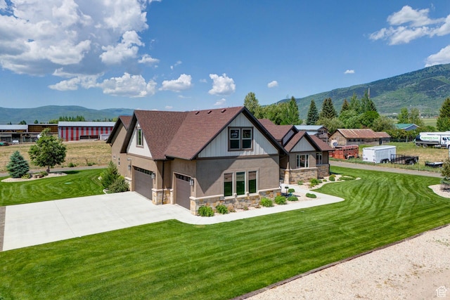 84 W 2100 N, Kamas, UT 84036 - view of front of property with driveway, a garage, stone siding, a mountain view, and a front lawn