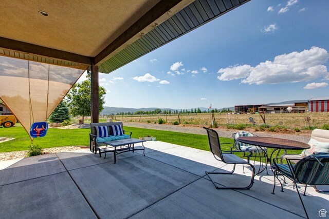 84 W 2100 N, Kamas, UT 84036 - view of patio featuring outdoor dining space, a rural view, fence, and a mountain view