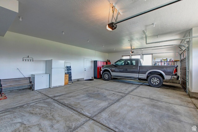 84 W 2100 N, Kamas, UT 84036 - garage with a garage door opener and freestanding refrigerator