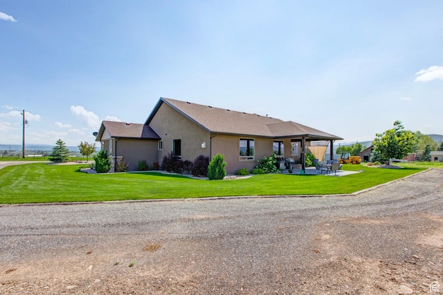 84 W 2100 N, Kamas, UT 84036 - view of front facade with a front yard, a patio, and stucco siding