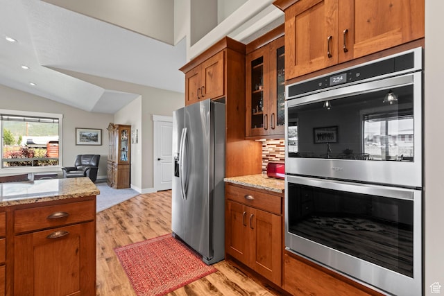 84 W 2100 N, Kamas, UT 84036 - kitchen with appliances with stainless steel finishes, brown cabinetry, light wood-style flooring, and glass insert cabinets