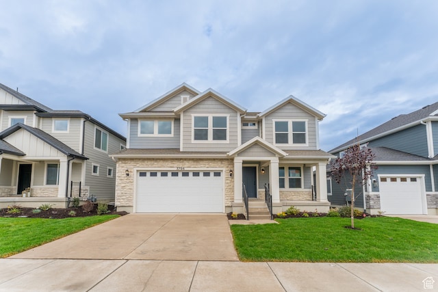 craftsman-style home featuring a front yard, covered porch, and a garage
