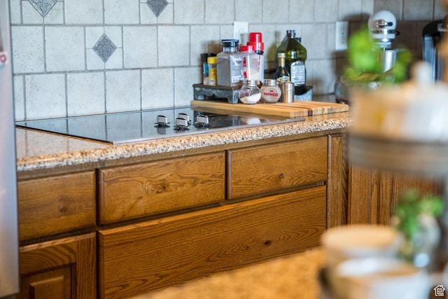 bar featuring backsplash and black electric cooktop