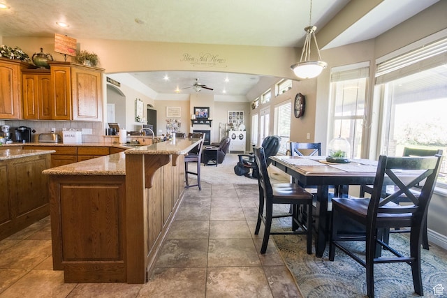 interior space featuring arched walkways, ceiling fan, and recessed lighting