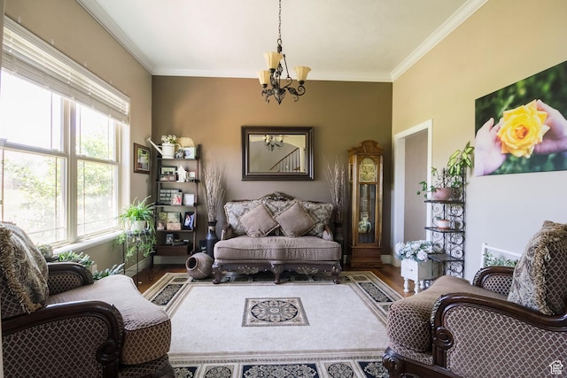 living room featuring wood finished floors, a notable chandelier, ornamental molding, and baseboards