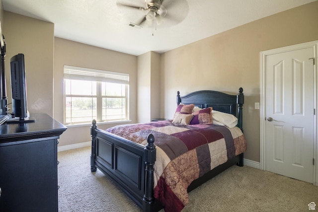 bedroom with visible vents, baseboards, a ceiling fan, and light colored carpet