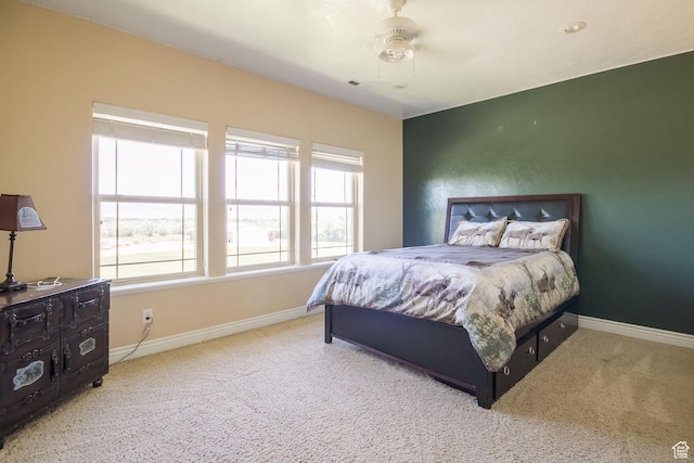 bedroom with carpet flooring, multiple windows, and baseboards
