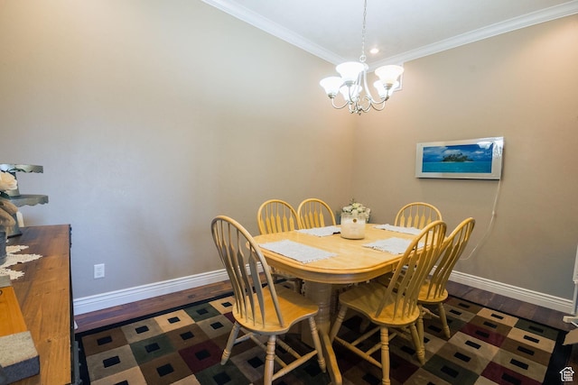 dining room featuring ornamental molding, baseboards, a notable chandelier, and wood finished floors